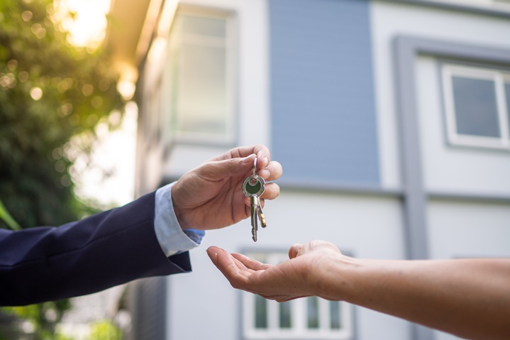 person handing keys to another person