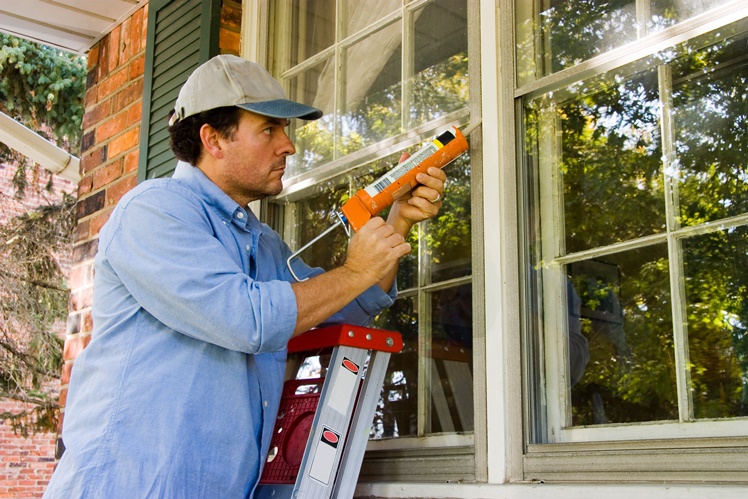 worker caulking window
